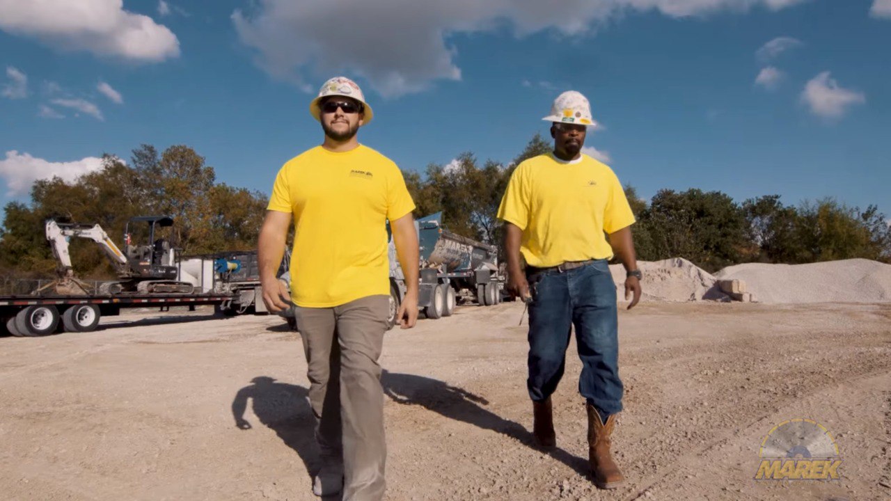 Marek Sawing & Drilling crew members walking across a jobsite